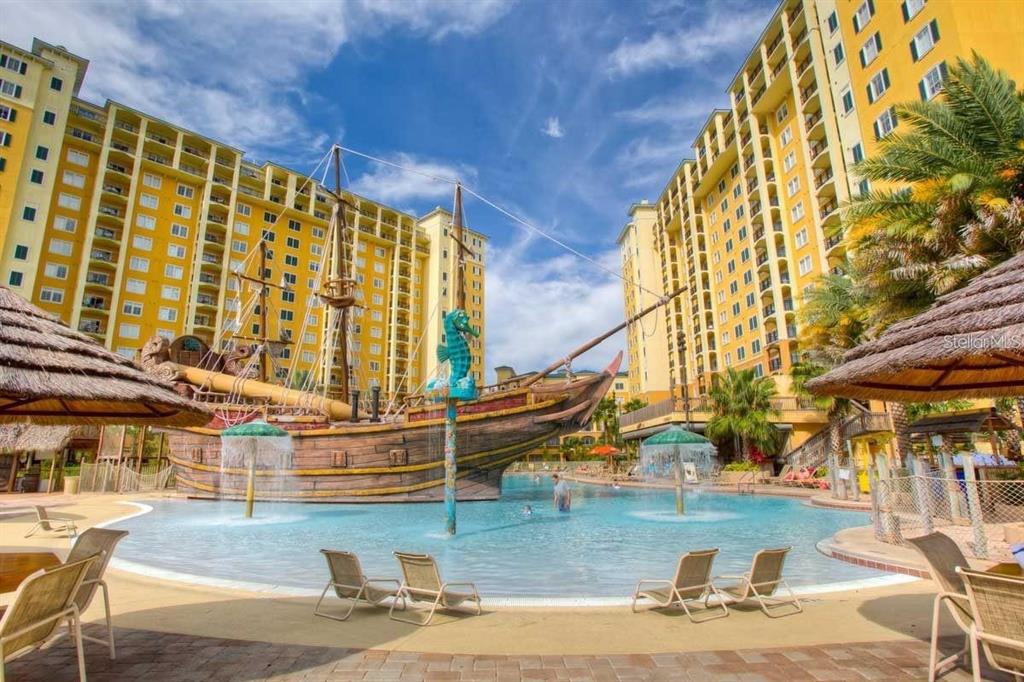 a view of swimming pool with outdoor seating