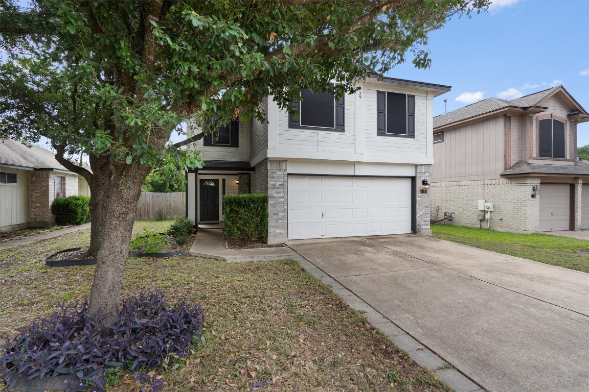 a front view of a house with a yard and garage