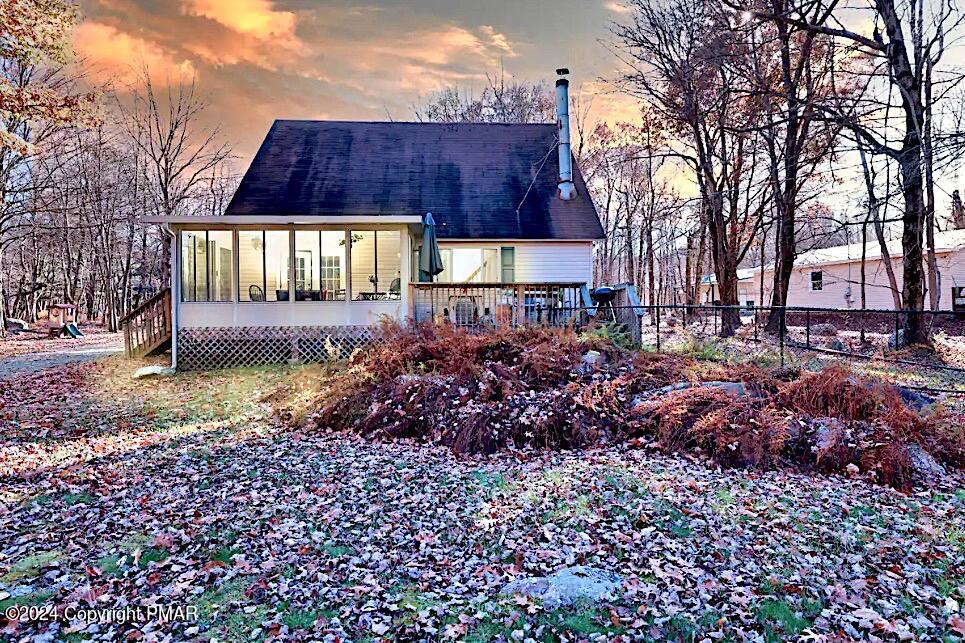 a view of a house with a yard and pathway