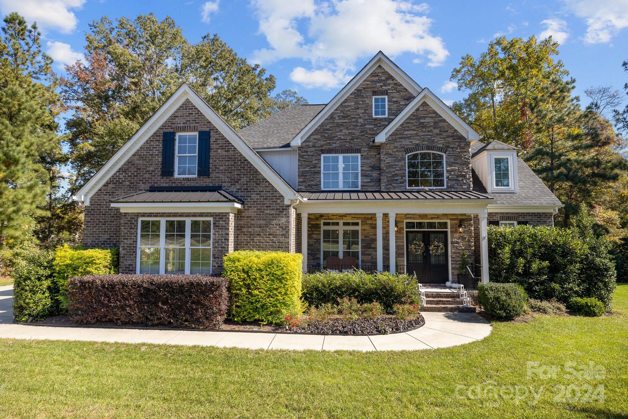 a front view of a house with a yard