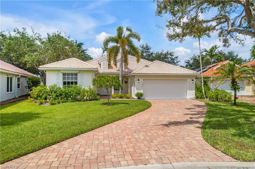 View of front of house with a front yard and a garage