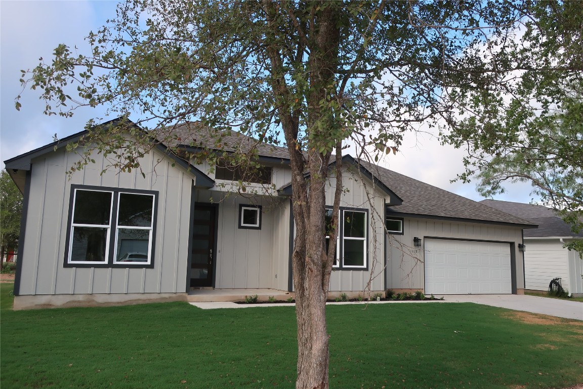 a front view of a house with a garden and yard