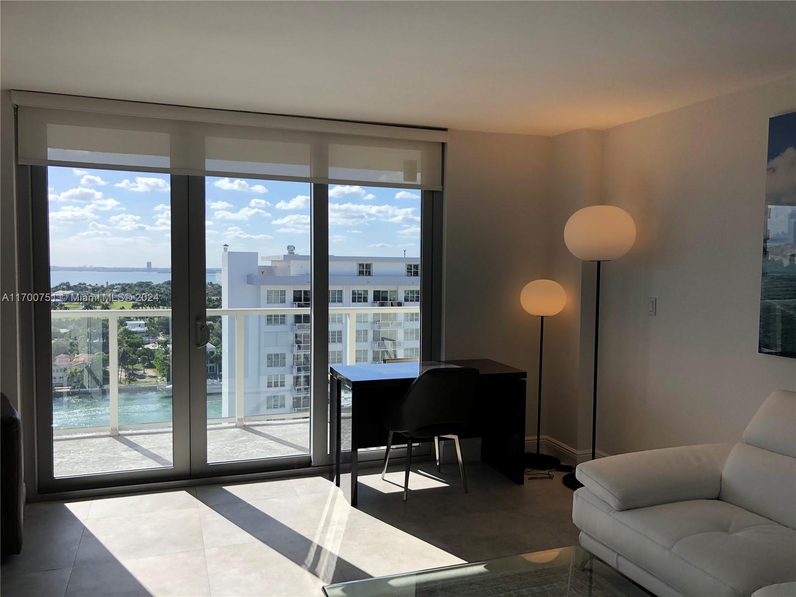 a view of a livingroom with furniture and a window