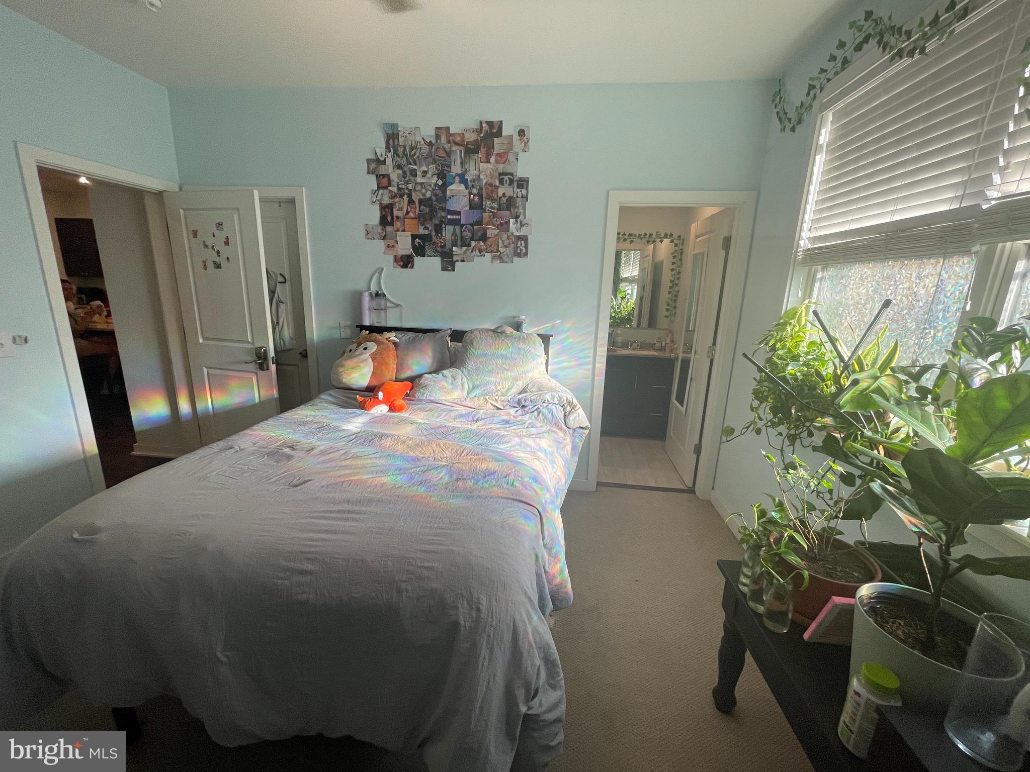 a bed room with a bed and a potted plant