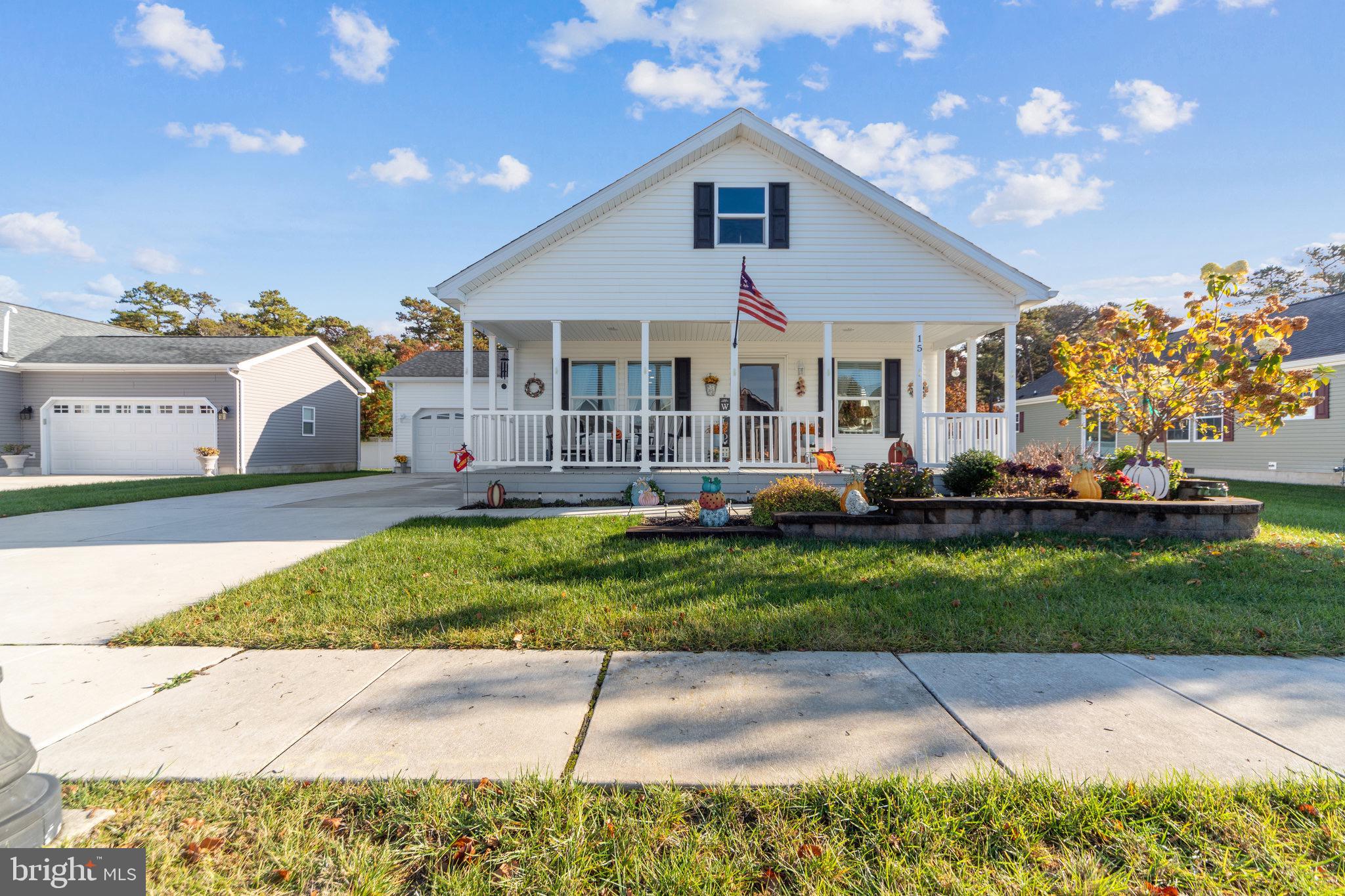 a front view of a house with a yard and outdoor seating