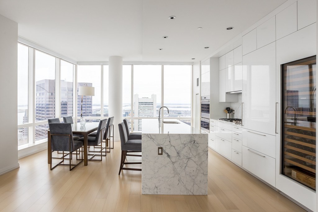 a living room with furniture and floor to ceiling windows