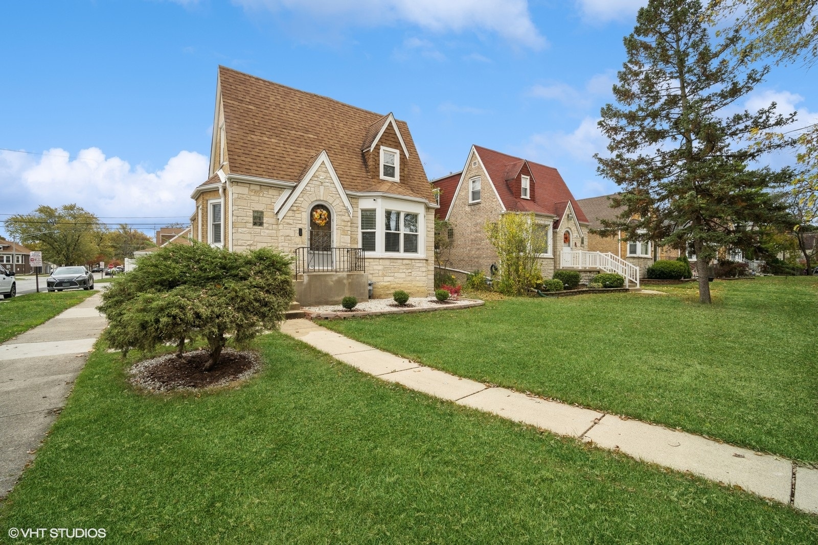 a front view of house with yard and green space