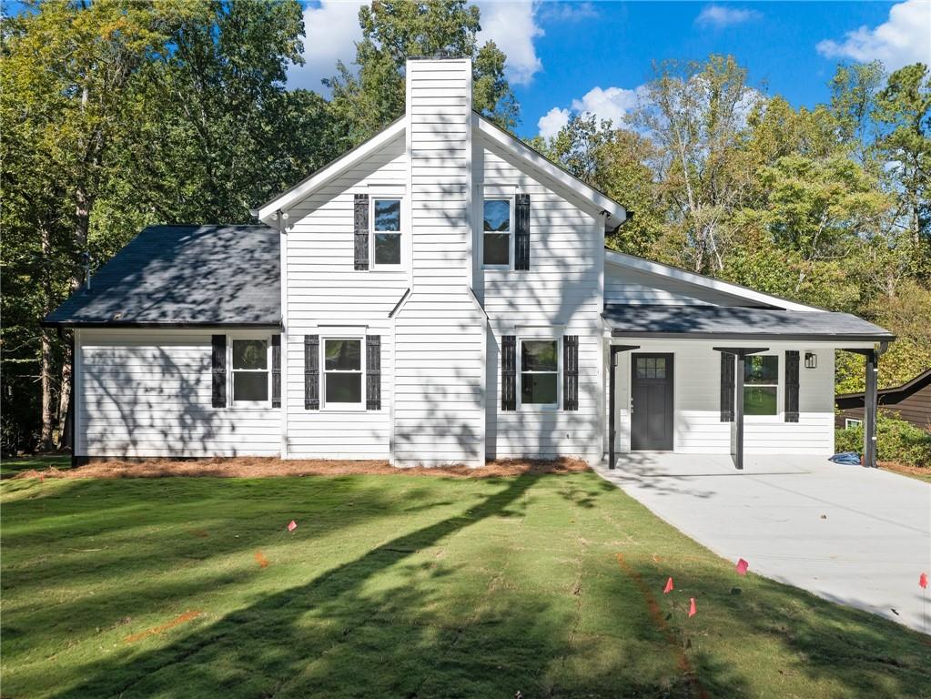 a front view of house with yard and green space