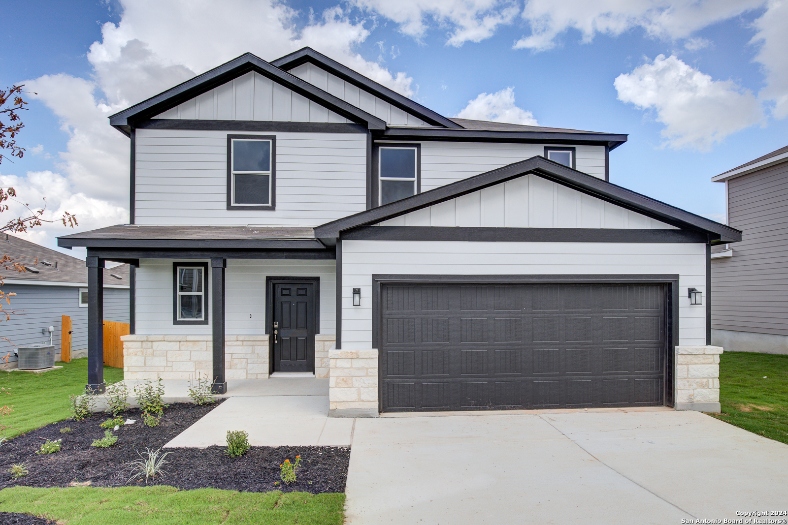 a front view of a house with a yard and garage