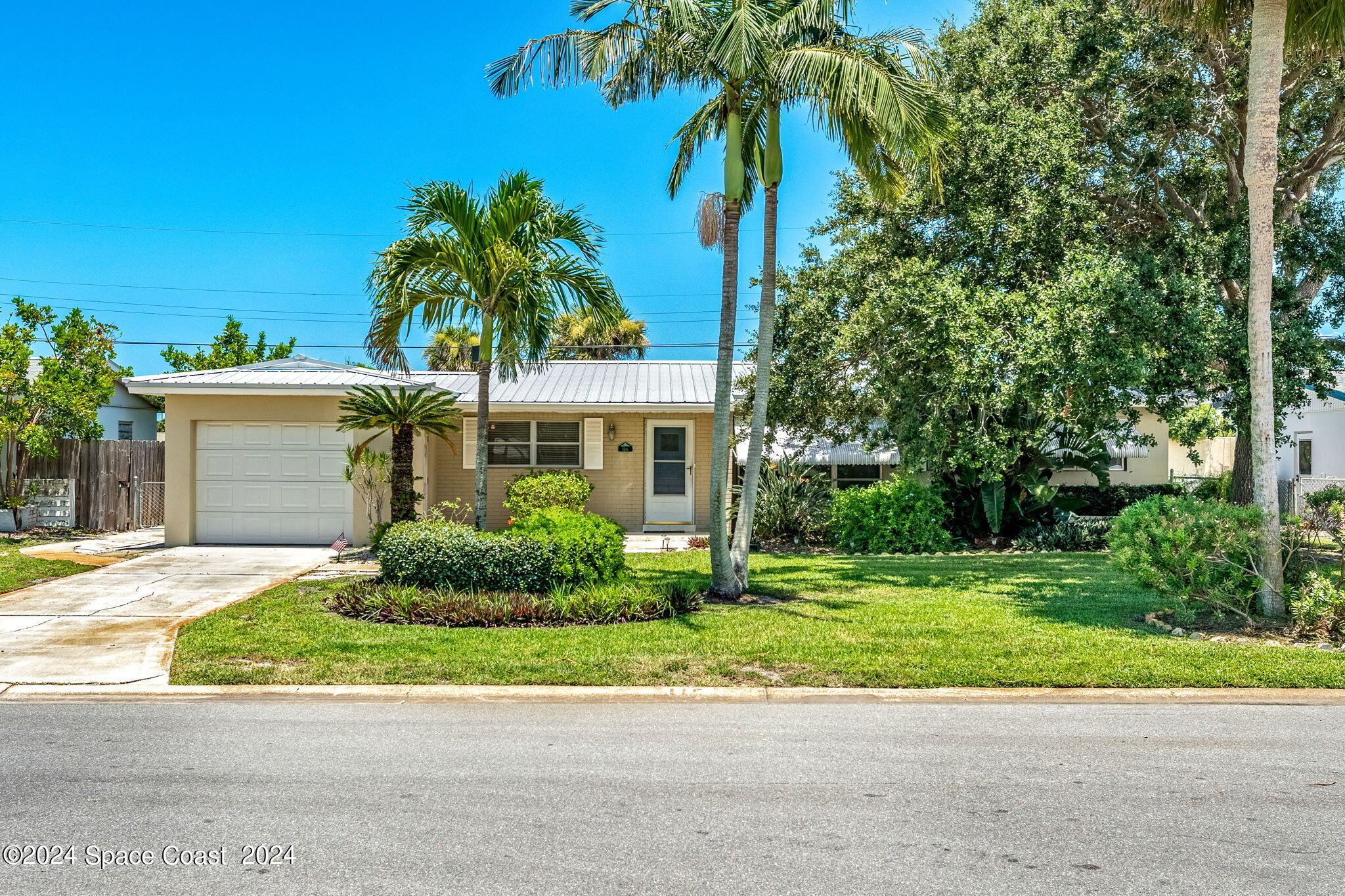 a front view of a house with a yard and a garage