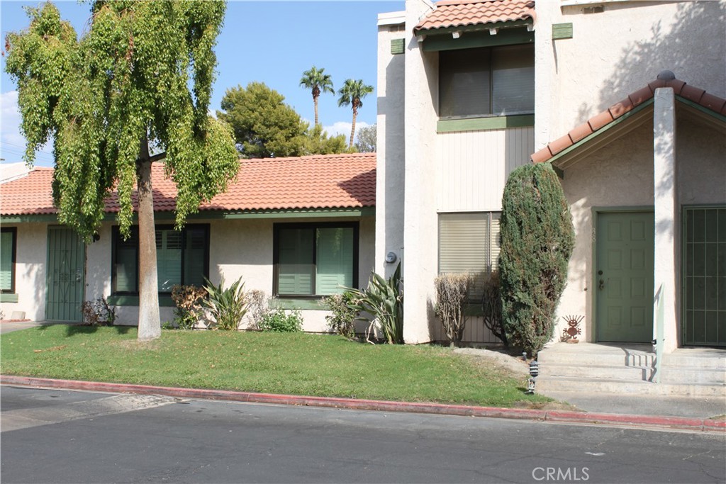 a view of a house with a yard and a car parked