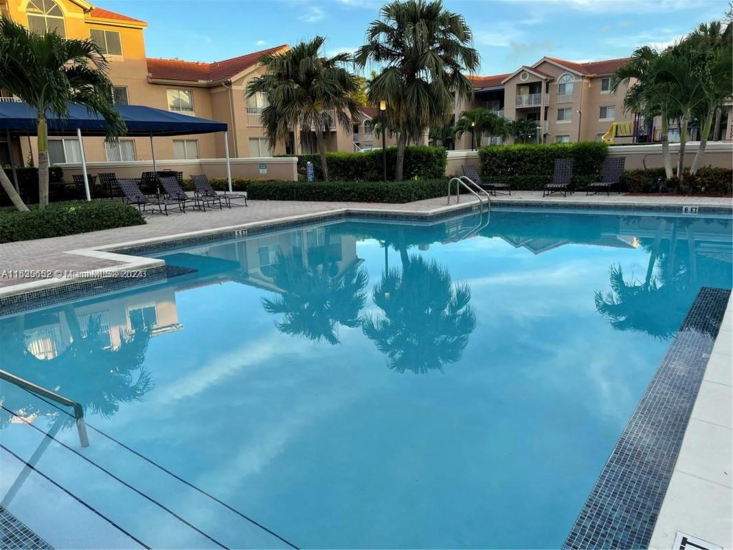 a house with swimming pool in front of it