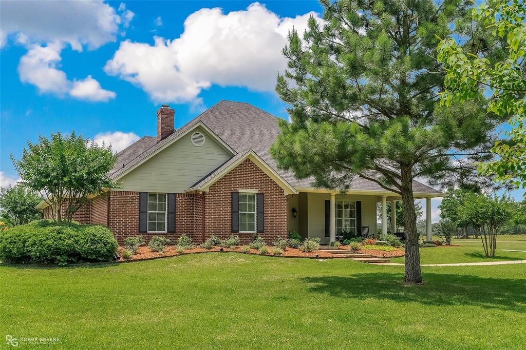 a front view of house with yard and outdoor seating