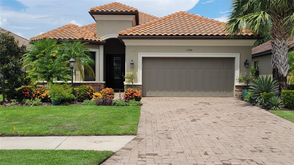 a front view of a house with a garden