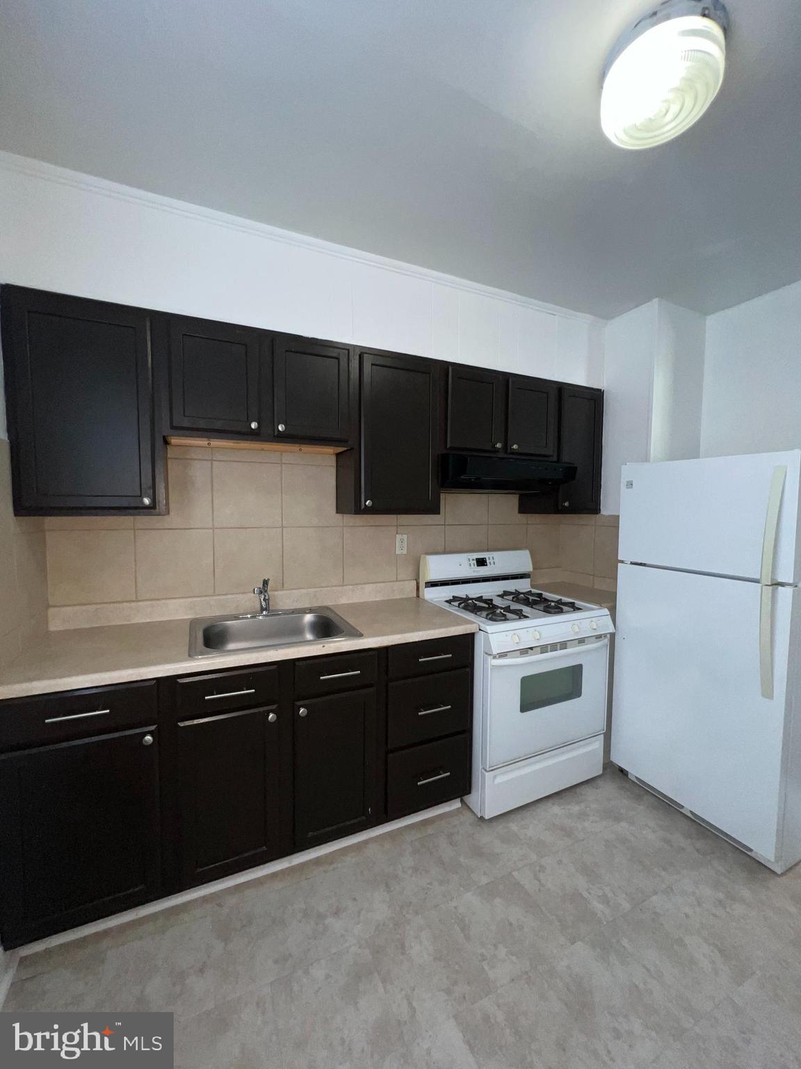 a kitchen with a sink a stove and microwave