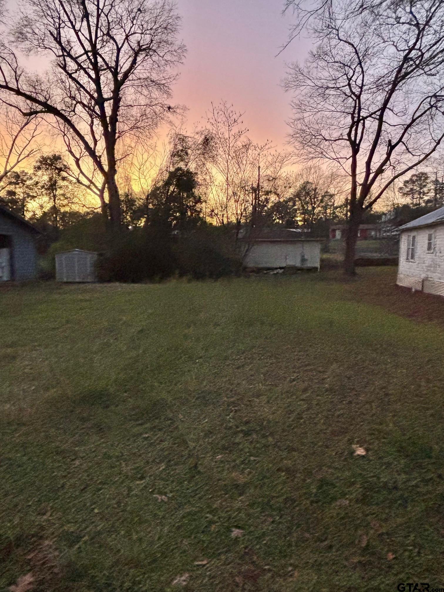 a view of patio with a yard