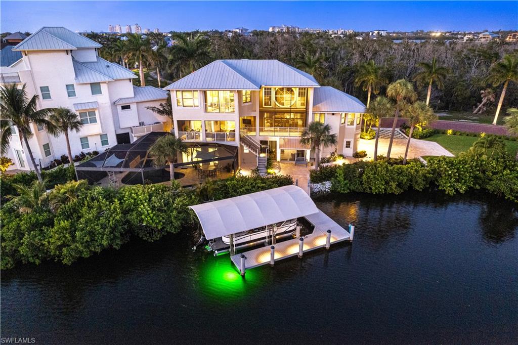 a aerial view of a house with swimming pool a yard and a patio