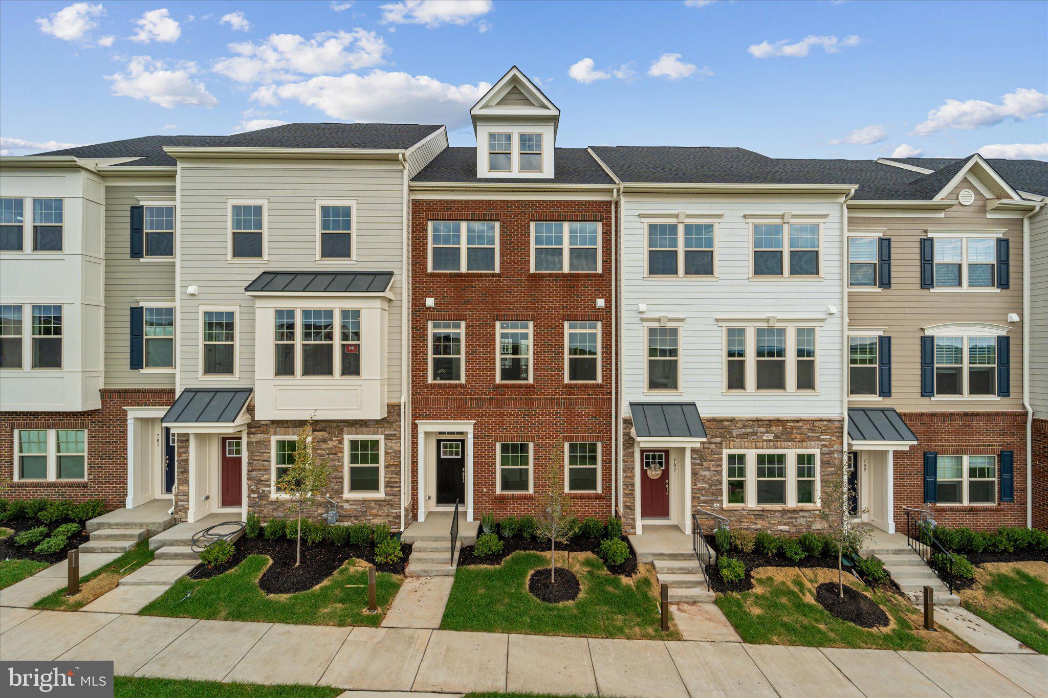 a front view of a residential apartment building with a yard