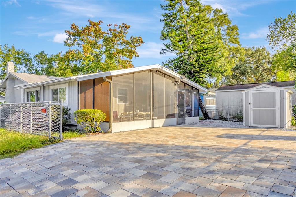 a view of a house with a yard and sitting area