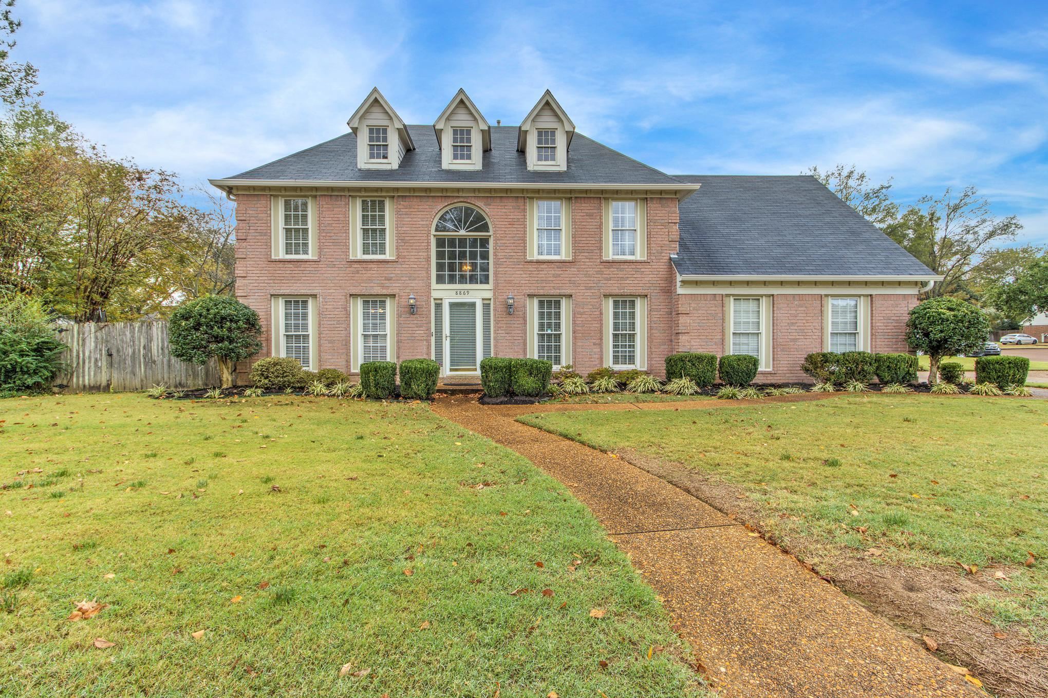 a front view of a house with a yard