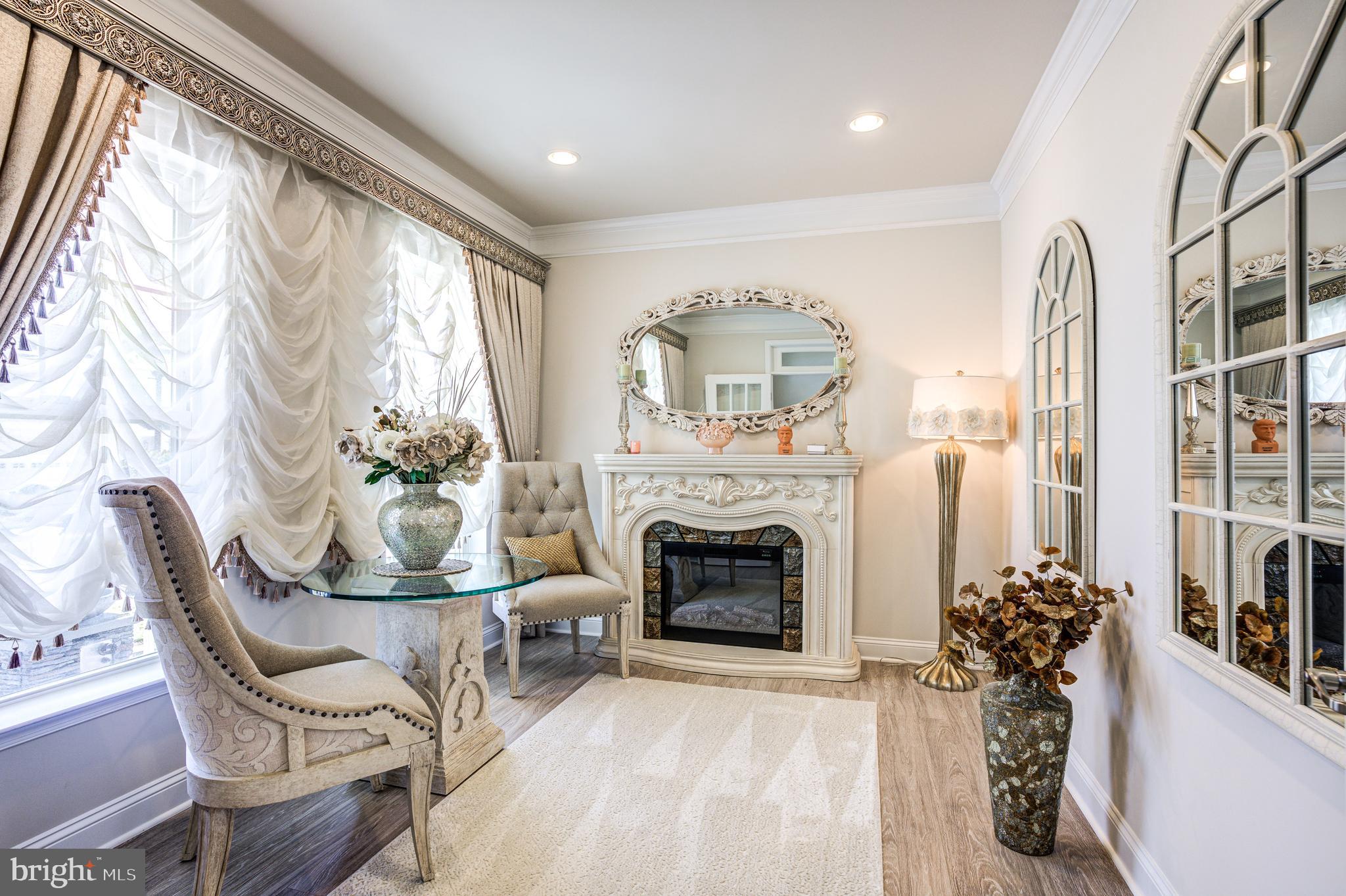 a living room with furniture a fireplace and a large window with outer view