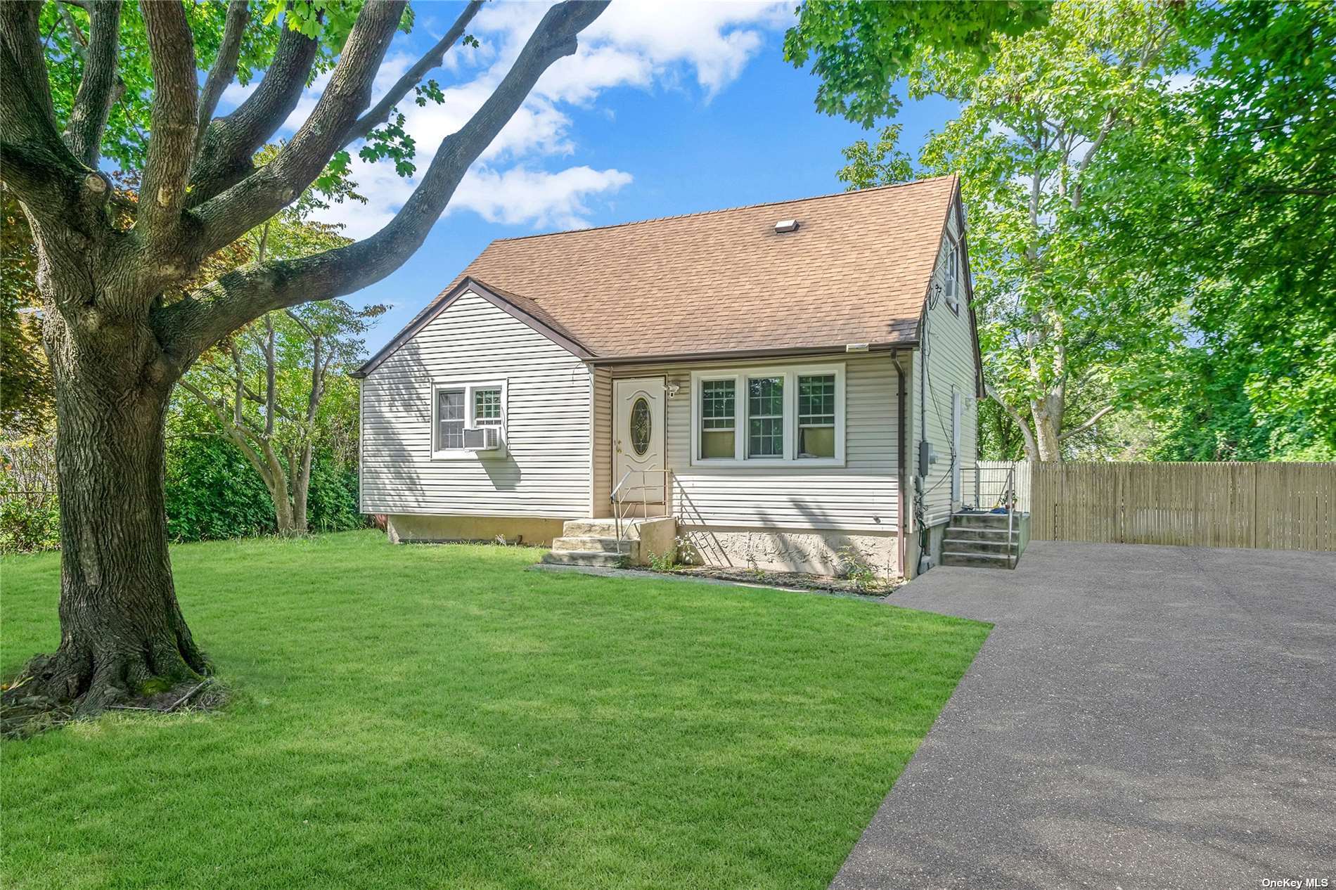 a view of a house with a yard and sitting area