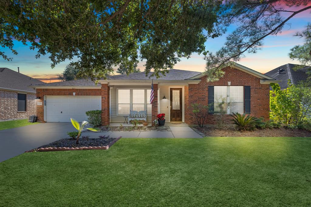 a house view with a sitting space and garden