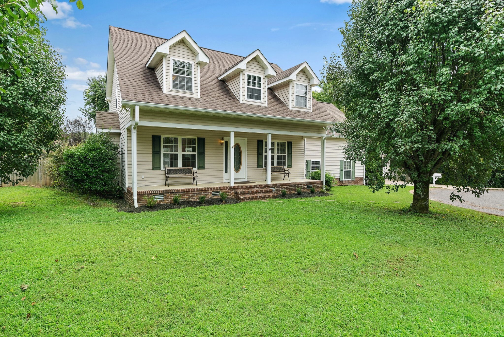 a front view of a house with a garden