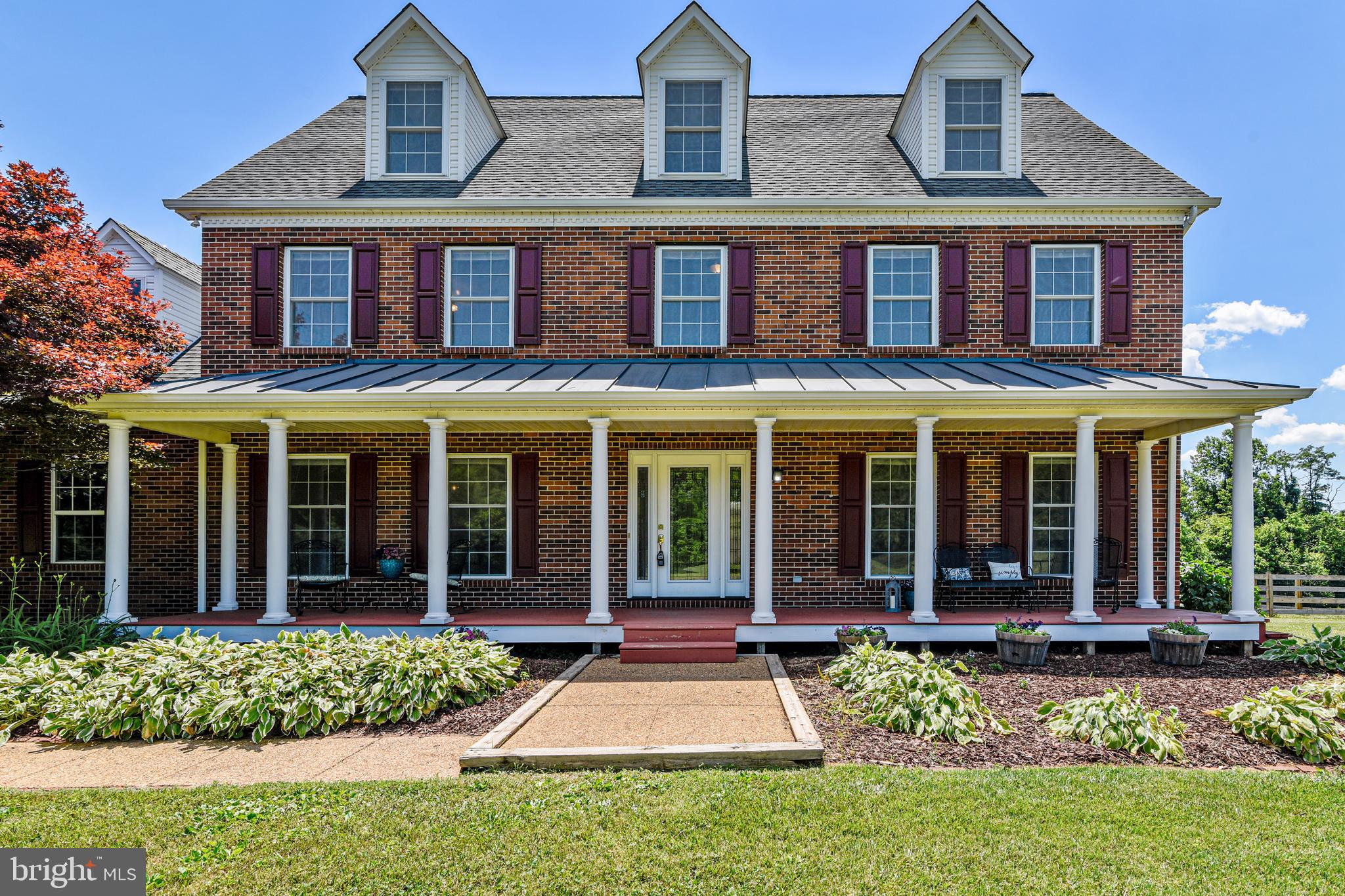 front view of a brick house with a yard