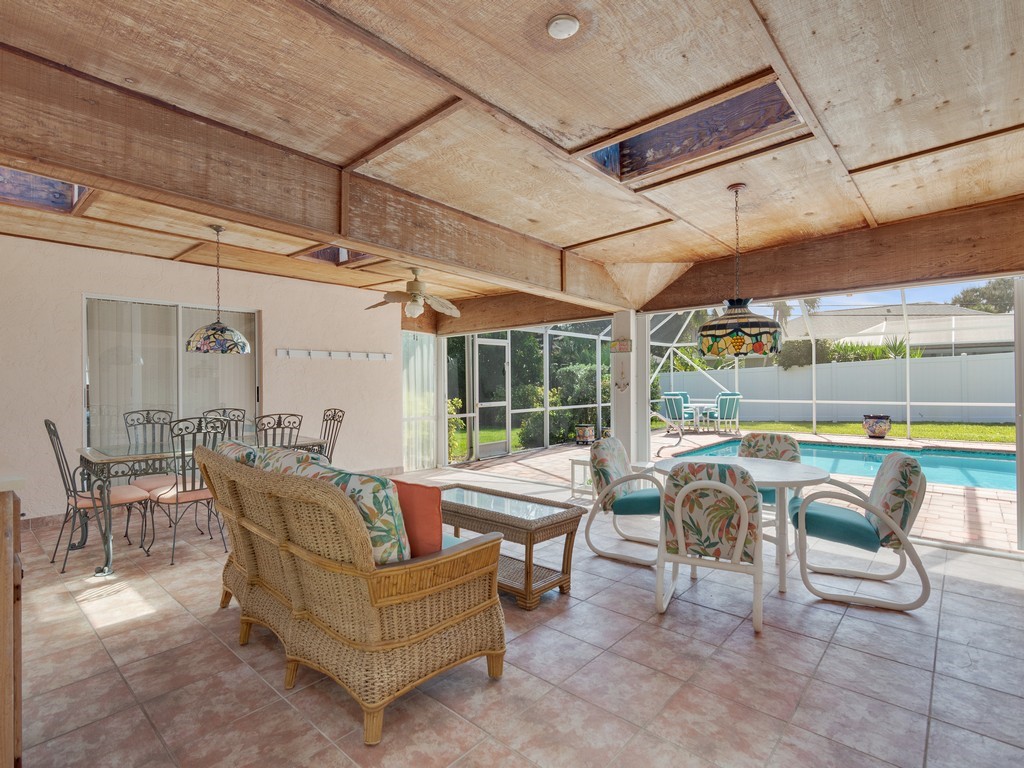 a living room with furniture and a floor to ceiling window