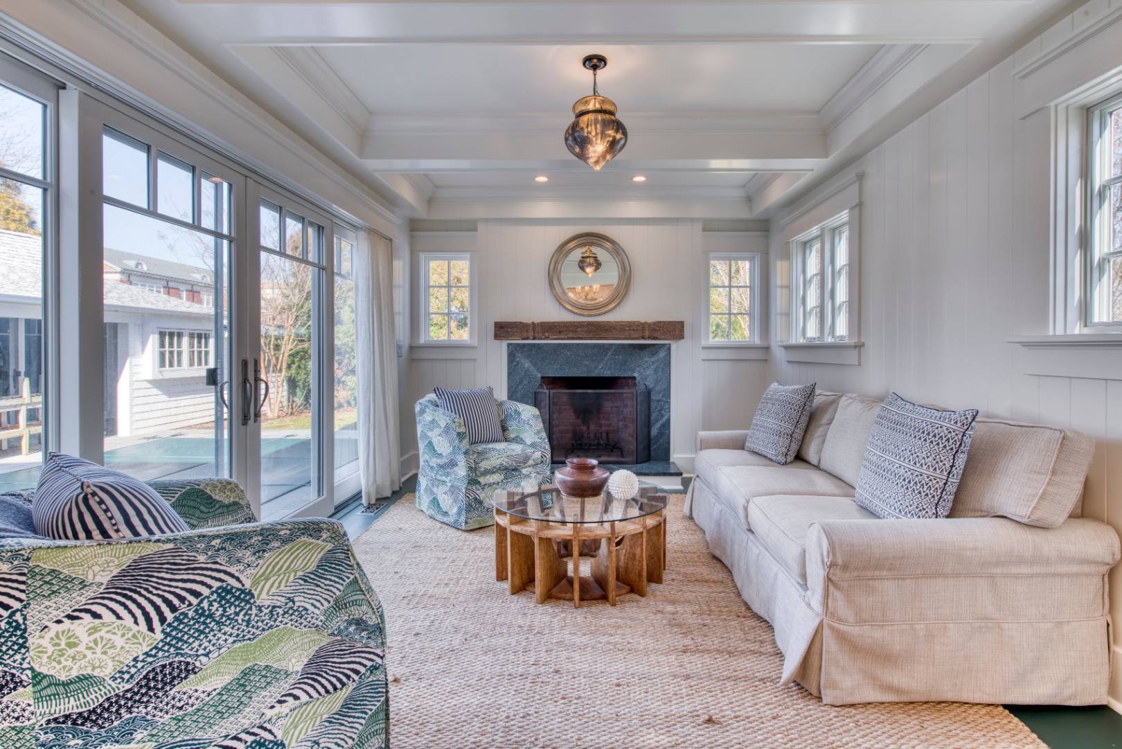 a living room with furniture a large window and a fireplace