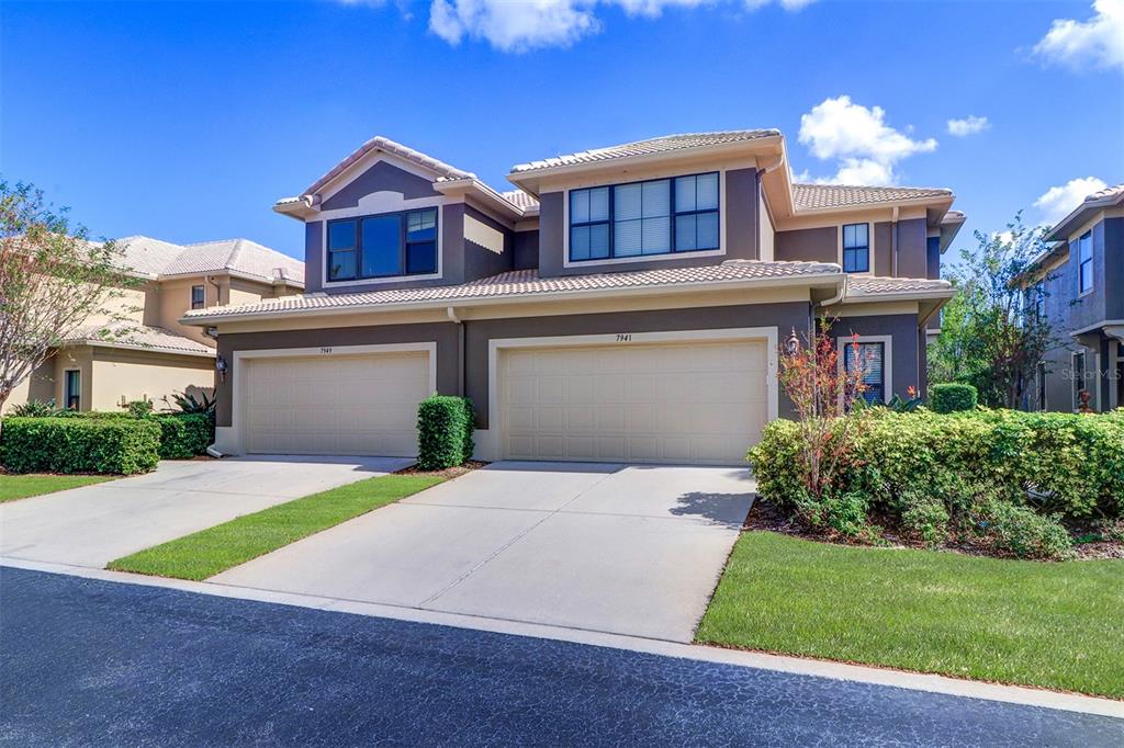 a front view of a house with a yard and garage