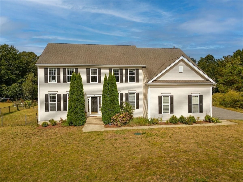 a front view of a house with yard