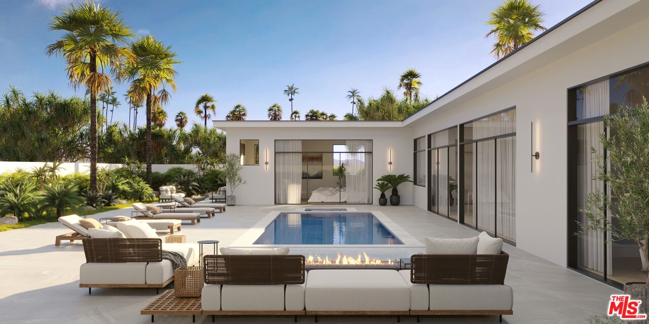 a view of a house with backyard and sitting area