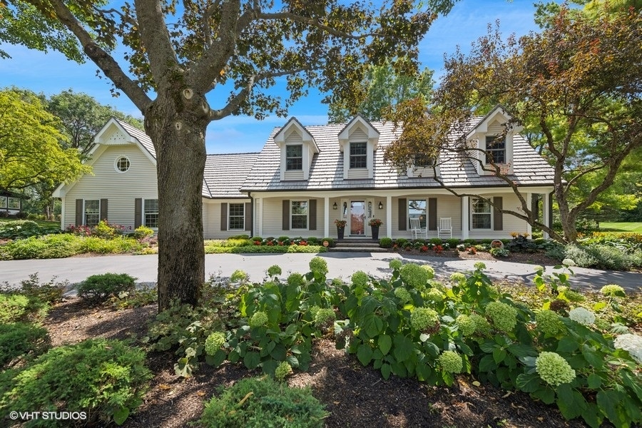 a front view of a house with yard and green space