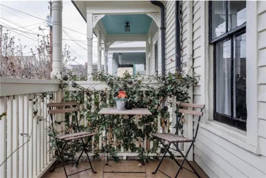 a view of a chairs and table in a balcony