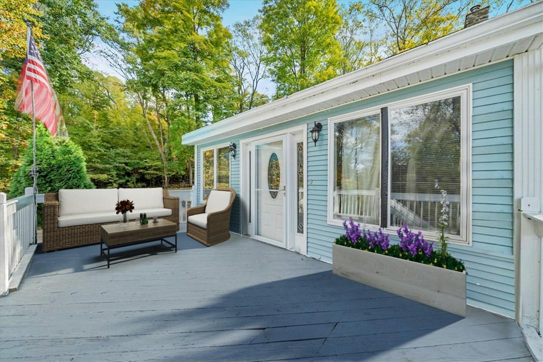 Wooden terrace with outdoor lounge area (Virtually Staged Furniture)