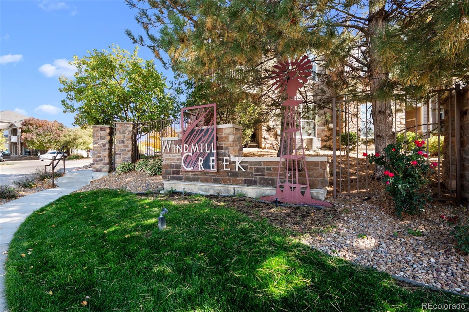 a front view of a house with a yard and tree s