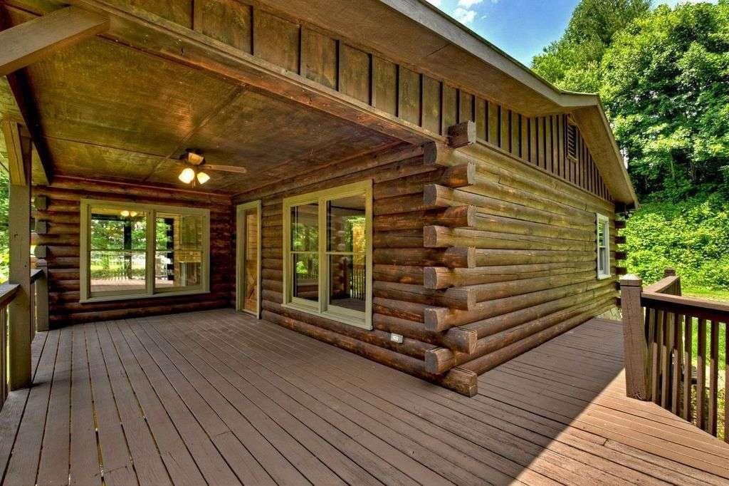 a view of backyard with deck and outdoor seating