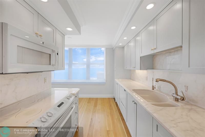 a kitchen with a sink stove and microwave