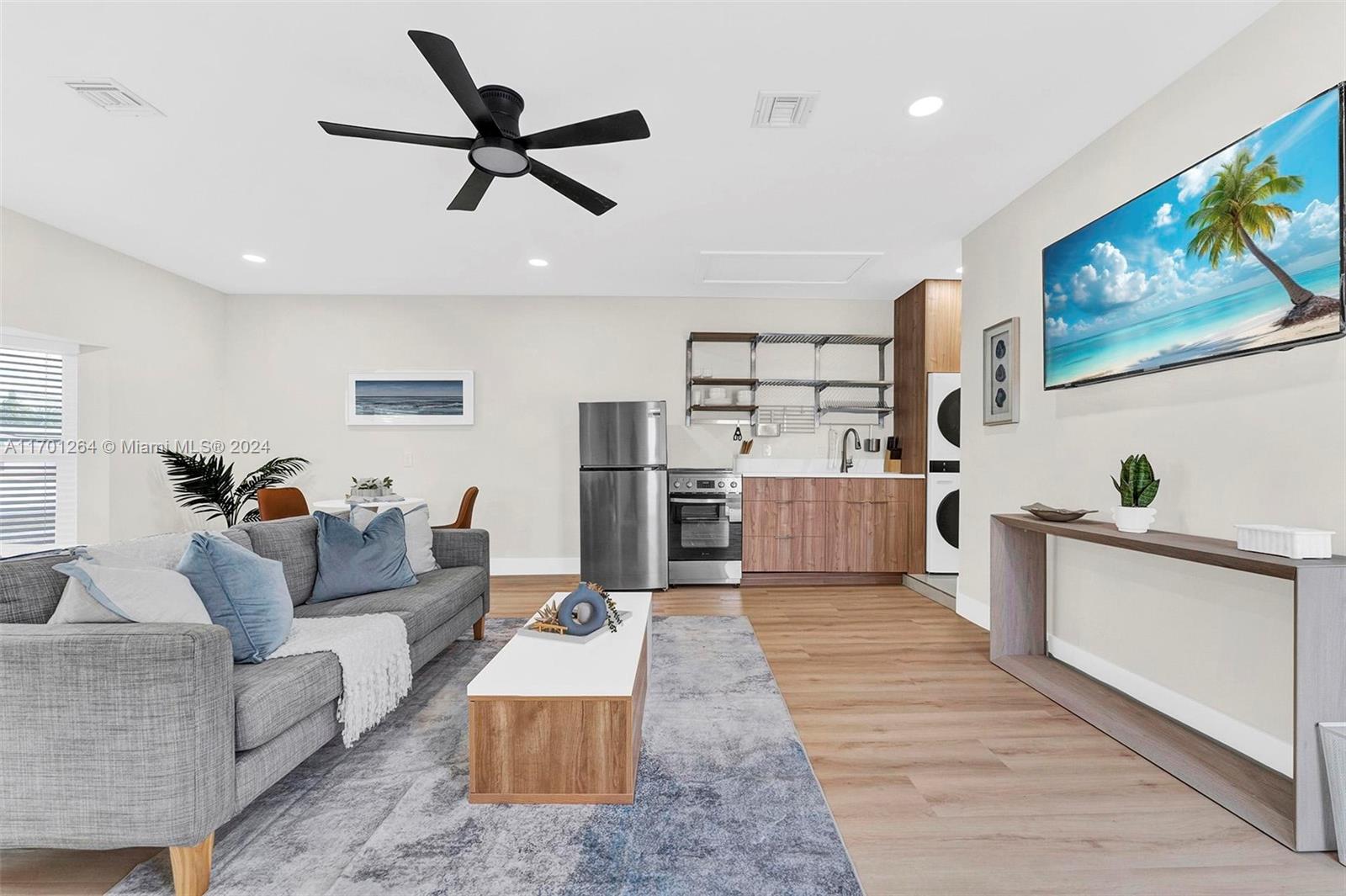 a living room with furniture and kitchen view