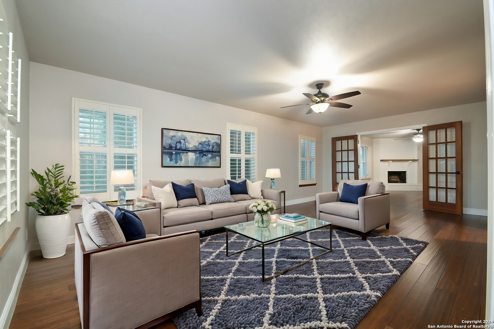 a living room with furniture a chandelier and a rug