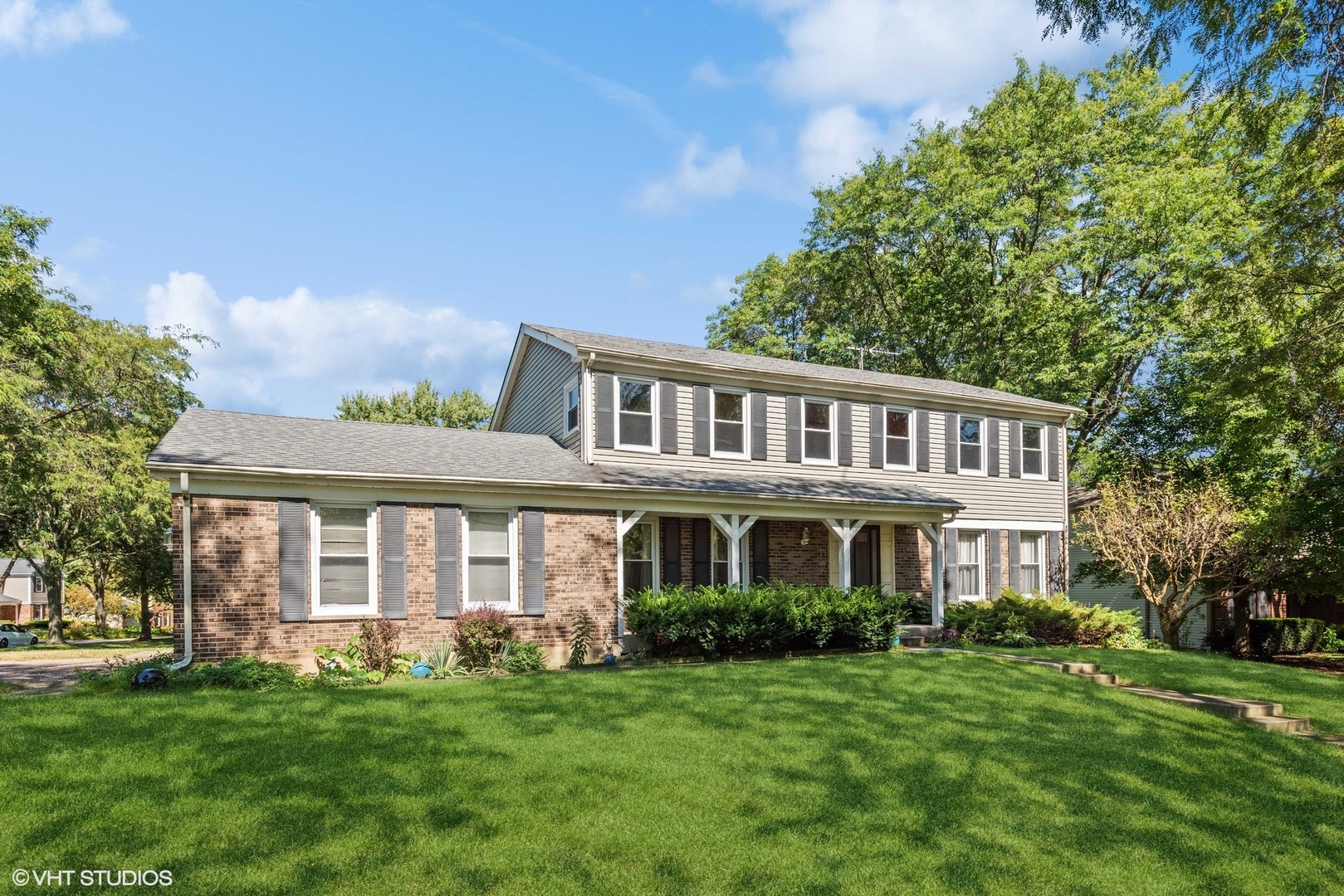 a front view of a house with a garden