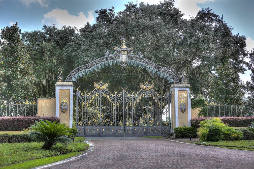 a front view of a house with a yard and fountain