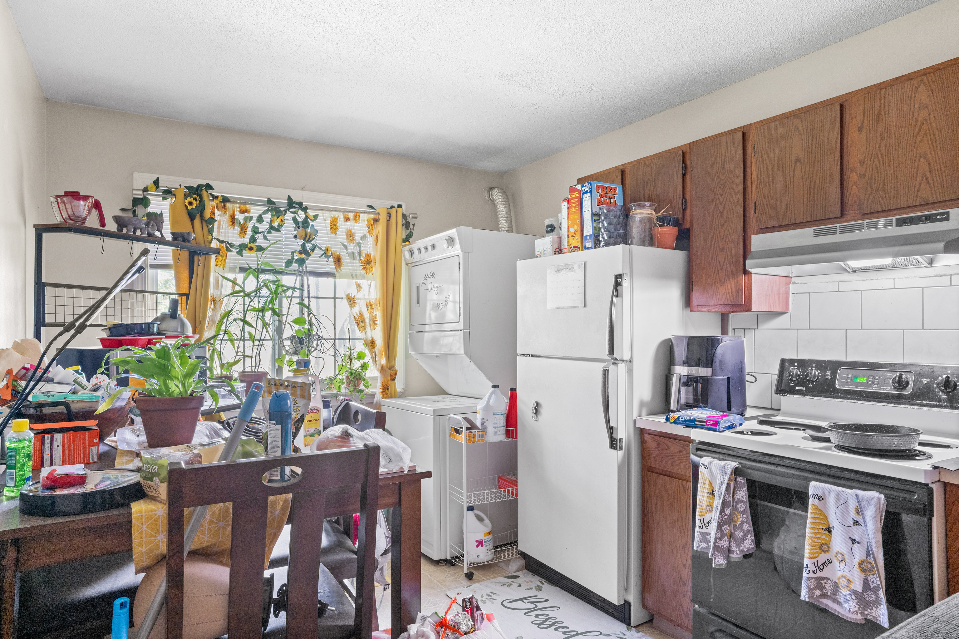 a kitchen with a refrigerator and a table