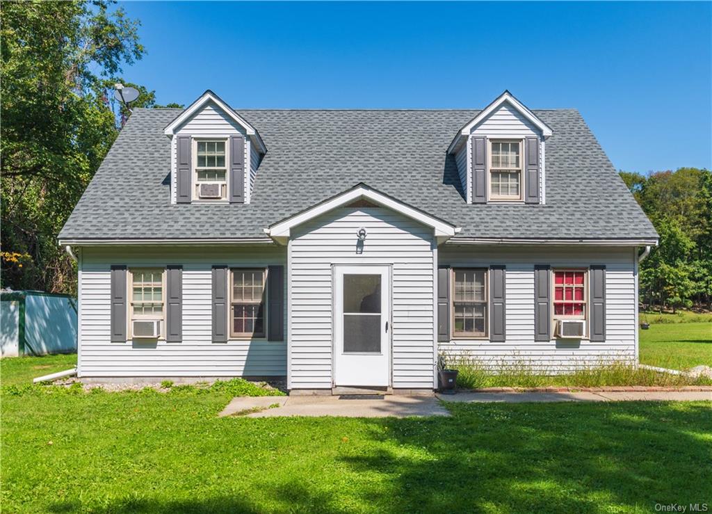 a front door view of a house with a yard