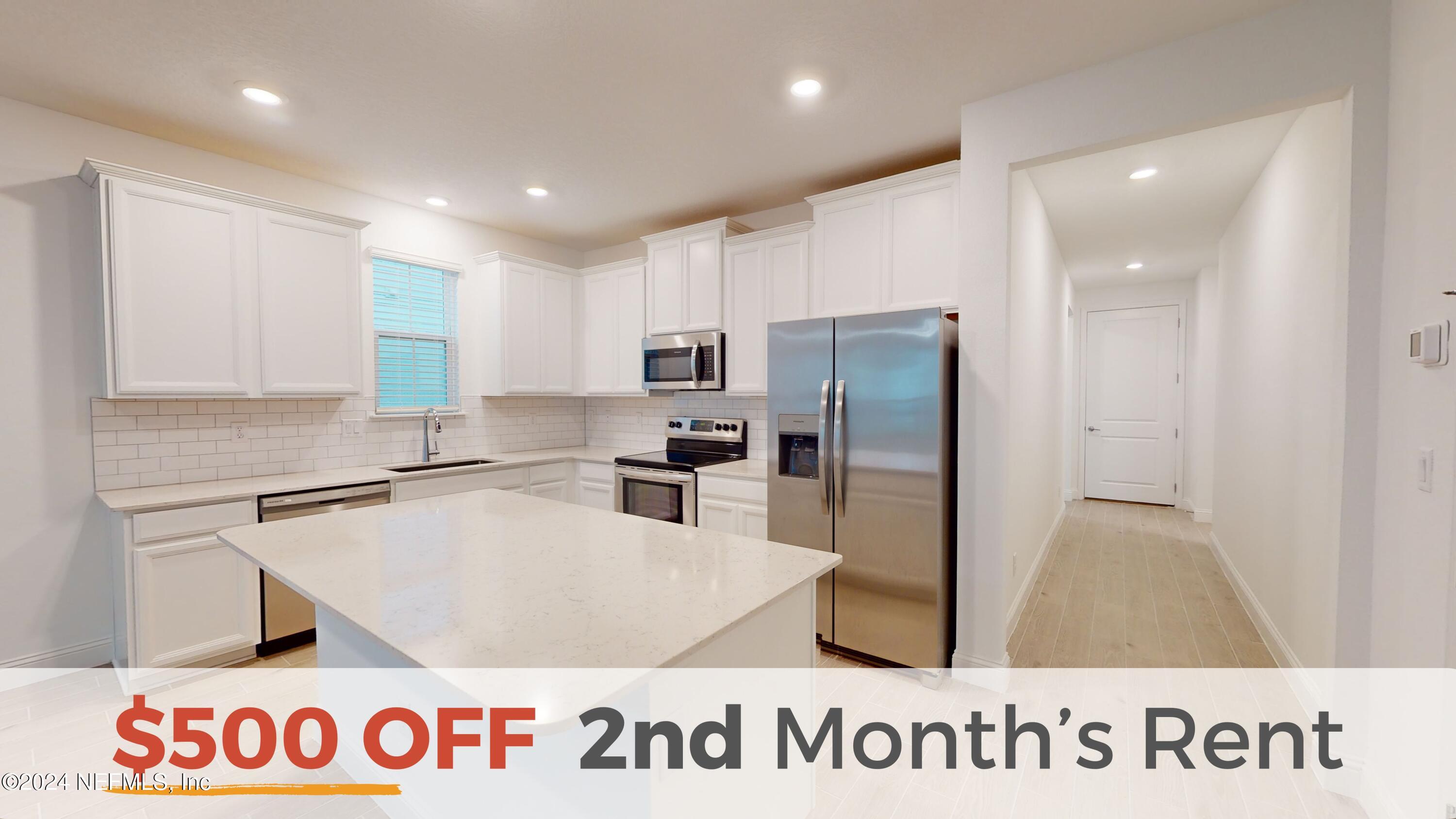 a kitchen with granite countertop a refrigerator and a sink