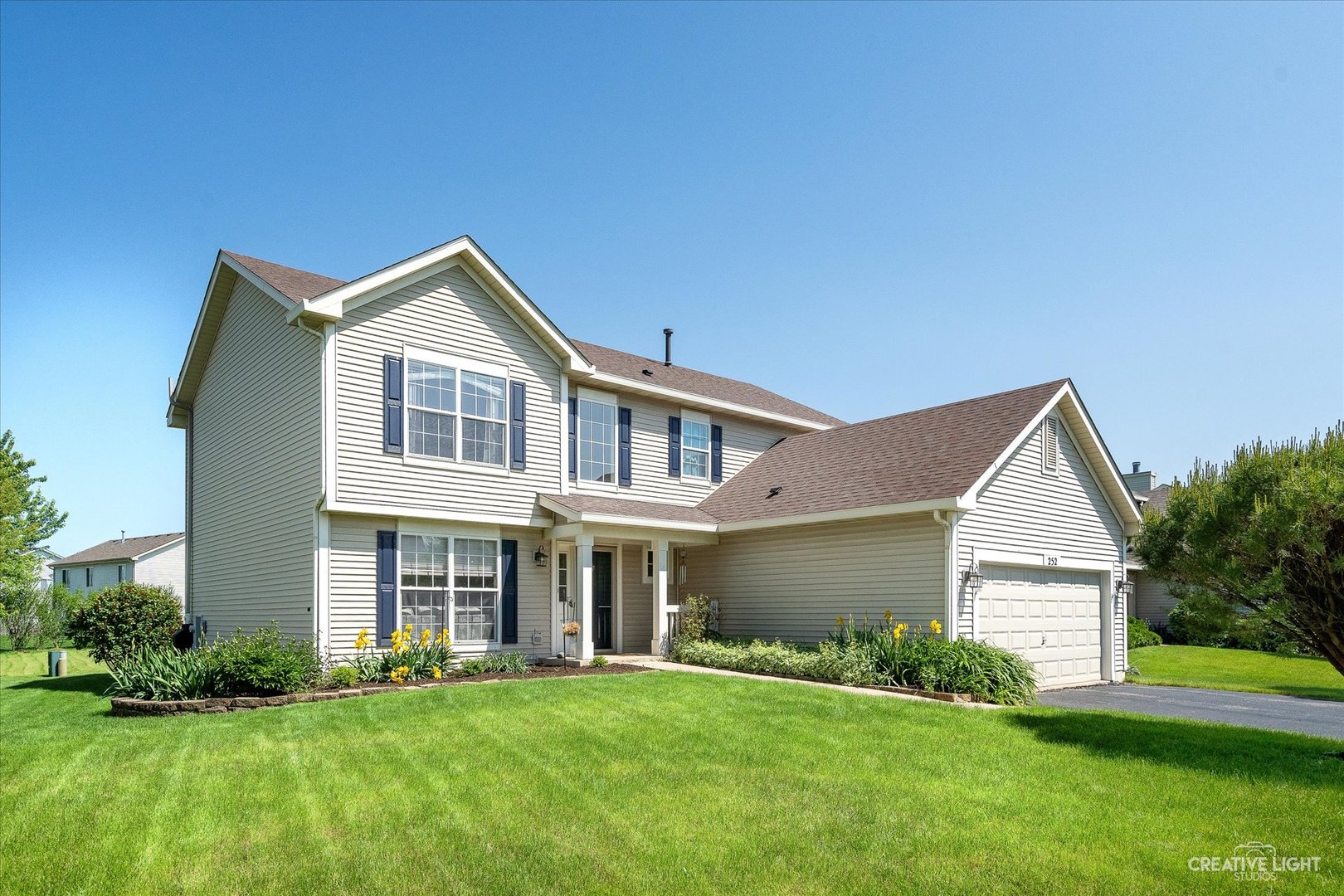 a front view of house with yard and green space