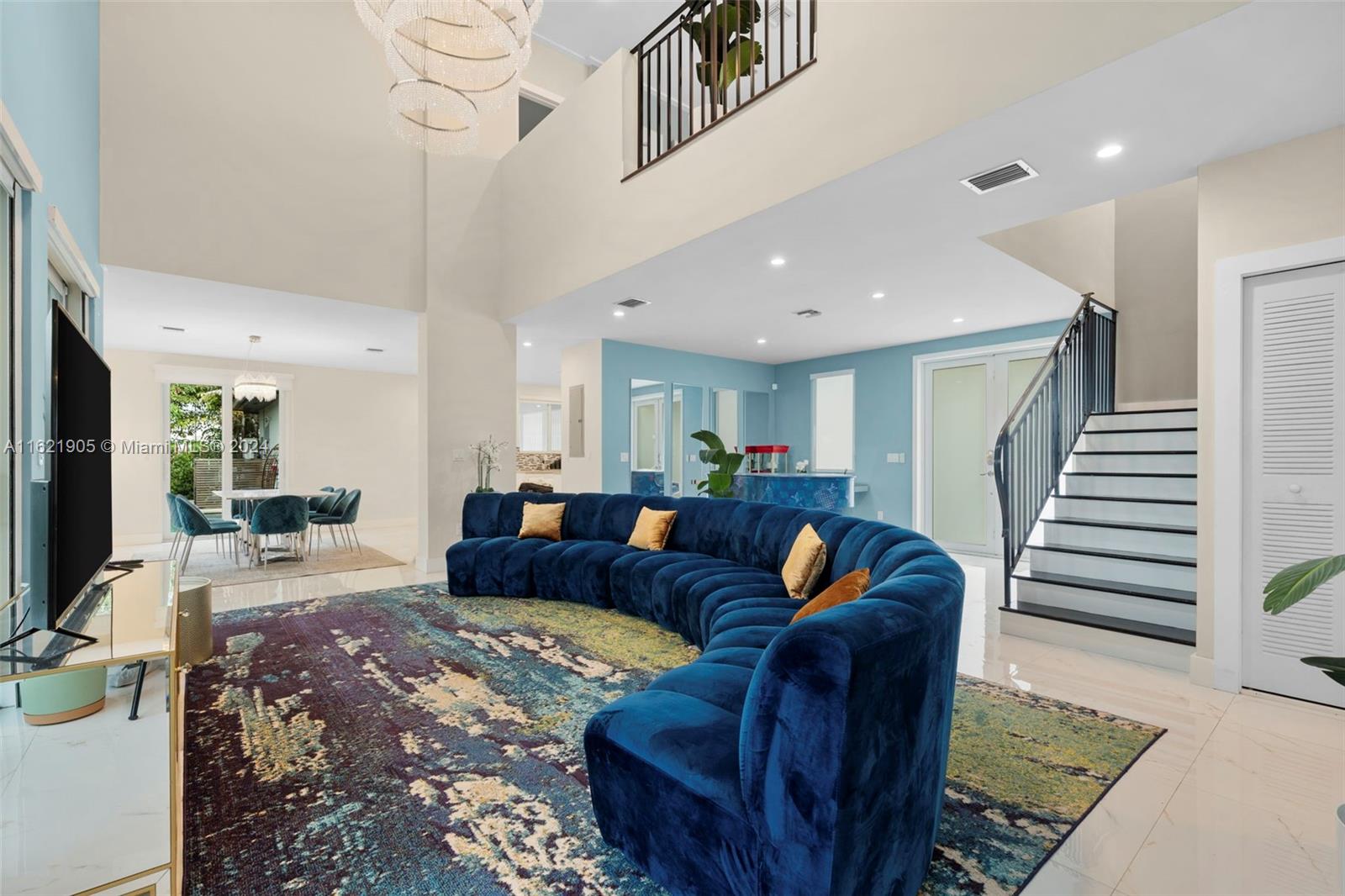 a living room with furniture or stairs and a chandelier