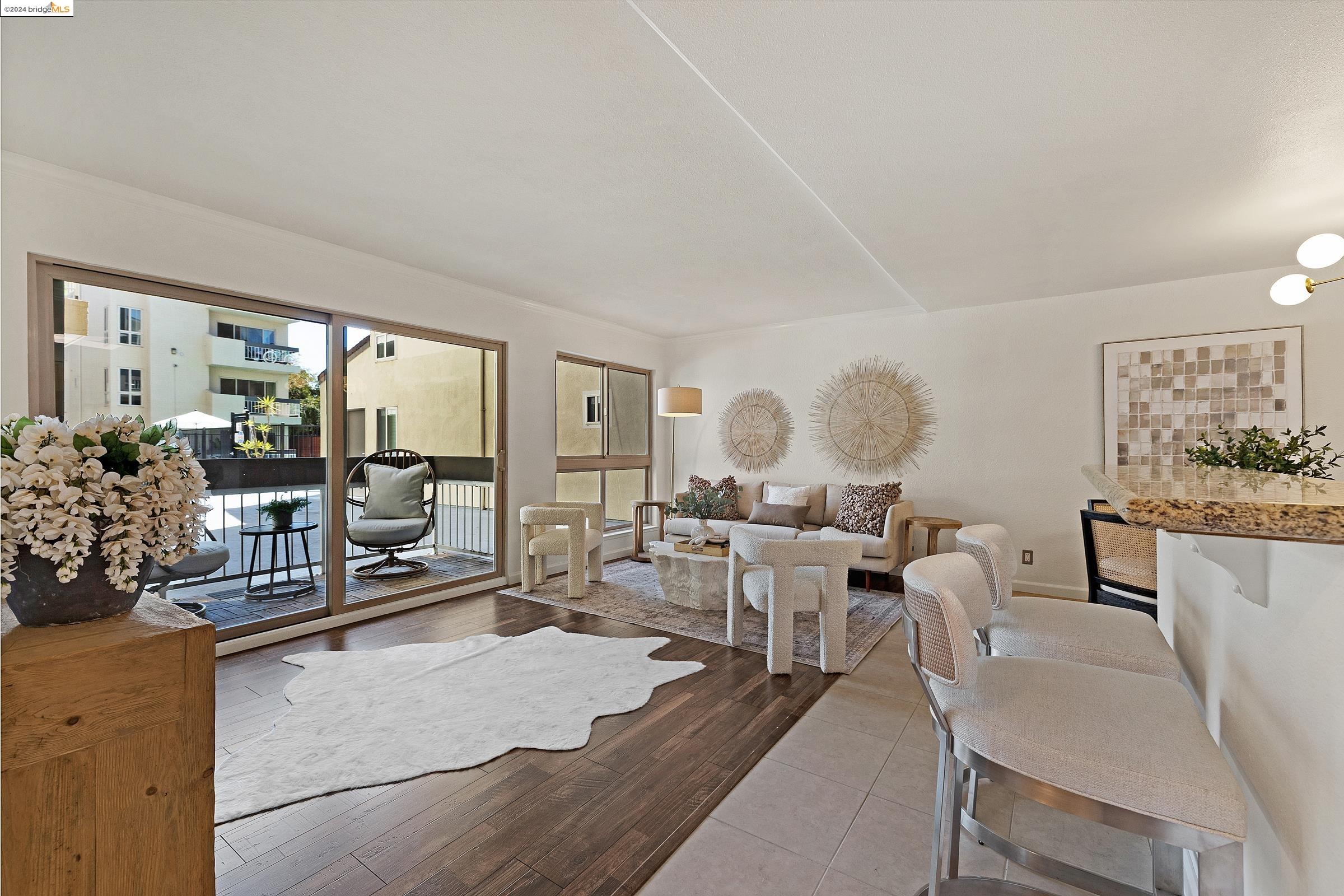 a living room with lots of white furniture and a large window